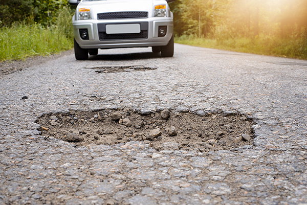 How Bad Is It to Drive Through Potholes?